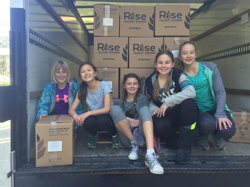 Rise Against Hunger 2018 kids with boxes in truck